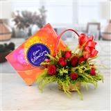 Send 12 Red Roses in a Round Basket with Celebration Chocolate Gift Hampers to Davangere Send 12 Red Roses in a Round Basket with Celebration Chocolate Gift Hampers to Davangere