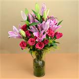 Send 24 Pcs Pink Rose & 5 Stem Lily in a Glass Vase Flowers to Madurai Send 24 Pcs Pink Rose & 5 Stem Lily in a Glass Vase Flowers to Madurai