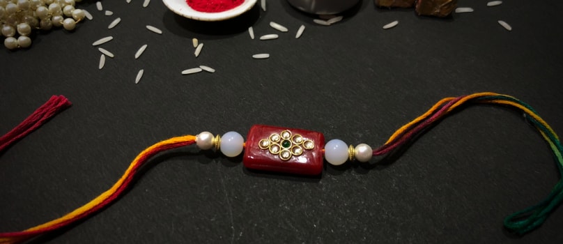 Red Tablet Gold Drop Rakhi Red Tablet Gold Drop Rakhi