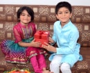 Small Brother Giving Gift to Small Sister
